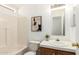 Bathroom with vanity and tub, complemented by stylish modern art at 7707 E Garnet Ave, Mesa, AZ 85209