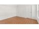 Bright and airy bedroom featuring laminate flooring and white walls with closet space at 7707 E Garnet Ave, Mesa, AZ 85209