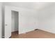 Bright bedroom with wood flooring and closet for ample storage space at 7707 E Garnet Ave, Mesa, AZ 85209