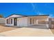 Charming single-story home featuring a gravel front yard, carport, and black and white trim at 7707 E Garnet Ave, Mesa, AZ 85209
