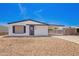 Charming single-story home featuring a gravel front yard, carport, and black and white trim at 7707 E Garnet Ave, Mesa, AZ 85209