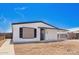 Charming single-story home featuring a gravel front yard, carport, and black and white trim at 7707 E Garnet Ave, Mesa, AZ 85209
