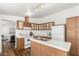 Well-maintained kitchen featuring white appliances, wooden cabinets, and laminate countertops at 7707 E Garnet Ave, Mesa, AZ 85209