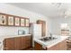 Charming kitchen featuring wood cabinets and a large sink with white countertops at 7707 E Garnet Ave, Mesa, AZ 85209