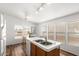 Bright kitchen with a double sink island and lots of natural light from large windows at 7707 E Garnet Ave, Mesa, AZ 85209