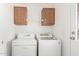 Functional laundry room with washer, dryer and storage cabinets at 7707 E Garnet Ave, Mesa, AZ 85209