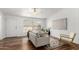 Bright living room with hardwood floors, white walls, modern decor, and a ceiling fan at 7707 E Garnet Ave, Mesa, AZ 85209