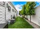 Backyard featuring artificial turf, landscaping, and a brick home exterior at 7770 E Camelback Rd # 11, Scottsdale, AZ 85251