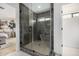 Modern bathroom featuring a glass-enclosed shower with stylish tile work and a glimpse of the adjacent bedroom at 7770 E Camelback Rd # 11, Scottsdale, AZ 85251