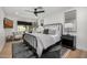 Comfortable bedroom featuring a wrought iron bed, stylish decor, and a cozy sitting area by the bright window at 7770 E Camelback Rd # 11, Scottsdale, AZ 85251