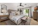 Luxurious bedroom featuring a tufted headboard, plush bedding, and access to a private outdoor patio at 7770 E Camelback Rd # 11, Scottsdale, AZ 85251