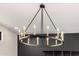Close-up of a stunning chandelier with candle-style lights and iron hardware at 7770 E Camelback Rd # 11, Scottsdale, AZ 85251