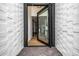 The front door leads to an open foyer with wood flooring and modern finishes at 7770 E Camelback Rd # 11, Scottsdale, AZ 85251