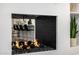 Modern fireplace with decorative fire balls and view of the kitchen at 7770 E Camelback Rd # 11, Scottsdale, AZ 85251