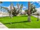 Expansive front lawn with mature trees and manicured landscaping at 7770 E Camelback Rd # 11, Scottsdale, AZ 85251
