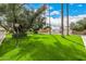 Lush green front lawn with mature trees providing ample shade at 7770 E Camelback Rd # 11, Scottsdale, AZ 85251