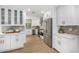 Bright kitchen with stainless steel appliances, white cabinetry, and hardwood flooring at 7770 E Camelback Rd # 11, Scottsdale, AZ 85251