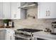 Gourmet kitchen featuring a stainless steel range with a pot filler and decorative backsplash at 7770 E Camelback Rd # 11, Scottsdale, AZ 85251