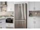Close up of the kitchen with stainless steel appliances, quartz countertops and white cabinets at 7770 E Camelback Rd # 11, Scottsdale, AZ 85251