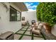 Private patio with comfortable seating, barbecue, and lush greenery for outdoor relaxation at 7770 E Camelback Rd # 11, Scottsdale, AZ 85251
