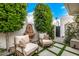 Private patio with comfortable seating, water feature, and lush greenery for outdoor relaxation at 7770 E Camelback Rd # 11, Scottsdale, AZ 85251
