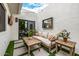 Private patio with comfortable seating, coffee tables and views of surrounding yard at 7770 E Camelback Rd # 11, Scottsdale, AZ 85251