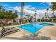 Sparkling community pool surrounded by palm trees and lounge chairs at 7770 E Camelback Rd # 11, Scottsdale, AZ 85251