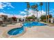 Inviting community pool and spa surrounded by lush landscaping and towering palm trees, perfect for relaxation at 7770 E Camelback Rd # 11, Scottsdale, AZ 85251