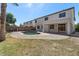 This backyard has a pool, a large concrete deck, green grass, and a privacy wall at 9618 E Monterey Ave, Mesa, AZ 85209