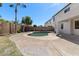 This backyard features a pool, two palm trees, lush green grass, and a spacious concrete deck at 9618 E Monterey Ave, Mesa, AZ 85209