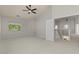 Large bedroom with neutral walls, vaulted ceiling, ceiling fan, and backyard view at 9618 E Monterey Ave, Mesa, AZ 85209
