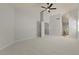 Spacious bedroom with neutral carpet, ceiling fan, and adjoining hallway at 9618 E Monterey Ave, Mesa, AZ 85209