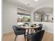 Breakfast nook features modern table, four upholstered chairs, and sliding glass doors at 9618 E Monterey Ave, Mesa, AZ 85209