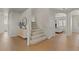 Spacious foyer with hardwood floors and a staircase that leads to the upper level, providing a grand entrance at 9618 E Monterey Ave, Mesa, AZ 85209