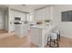 Clean, bright kitchen featuring white cabinets, an island with seating, and stainless steel appliances at 9618 E Monterey Ave, Mesa, AZ 85209