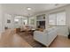 Bright living room with hardwood floors, neutral-toned sofas, and large windows for natural light at 9618 E Monterey Ave, Mesa, AZ 85209
