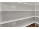 Walk-in pantry features multiple white shelves for ample storage at 9618 E Monterey Ave, Mesa, AZ 85209