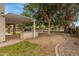 Large backyard with a built-in grill area, mature trees, and desert landscaping features at 9665 E Nido Ave, Mesa, AZ 85209