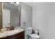 Cozy powder room featuring a decorative framed mirror and elegant fixtures at 9665 E Nido Ave, Mesa, AZ 85209