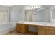 Bathroom with a double sink vanity, large mirror and separate tub at 9665 E Nido Ave, Mesa, AZ 85209