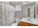 Bathroom featuring vanity, mirror and bath with shower, all illuminated by natural light at 9665 E Nido Ave, Mesa, AZ 85209
