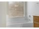 Bright bathroom featuring a white bathtub with window blinds allowing natural light at 9665 E Nido Ave, Mesa, AZ 85209