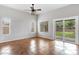 Bright bedroom with tile flooring, large window, and a sliding glass door at 9665 E Nido Ave, Mesa, AZ 85209