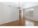 Open dining area features a chandelier, large window, and tile flooring at 9665 E Nido Ave, Mesa, AZ 85209