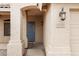 Inviting entryway featuring a blue front door, porch and textured exterior walls at 9665 E Nido Ave, Mesa, AZ 85209