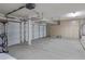 Spacious three-car garage with ample storage space and lots of lighting at 9665 E Nido Ave, Mesa, AZ 85209