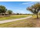 Scenic view of the golf course from the property, featuring lush greenery and mature trees at 9665 E Nido Ave, Mesa, AZ 85209