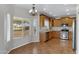 Kitchen with wood cabinetry, stainless steel appliances, and tile flooring at 9665 E Nido Ave, Mesa, AZ 85209
