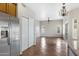 Bright living room with tiled flooring, neutral walls, and stainless steel refrigerator in background at 9665 E Nido Ave, Mesa, AZ 85209