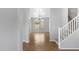 Bright living room featuring tile floors, neutral walls, chandelier, and open staircase at 9665 E Nido Ave, Mesa, AZ 85209